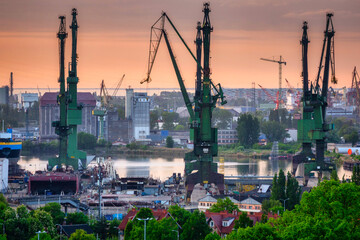 Shipyard cranes in Gdansk at sunset. Poland