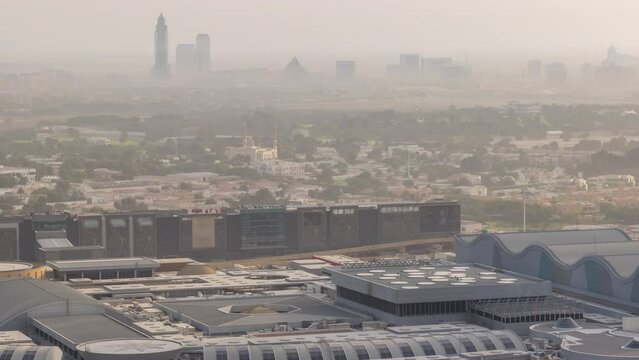Buildings around Deira and creek district in Dubai timelapse. Tall towers and shopping mall with city skyline aerial view. Dubai, UAE.