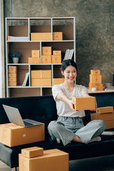 Asian woman working in modern warehouse and delivery service via modern technology