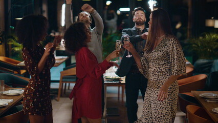 Friends celebrating new year together on fancy party meeting at night restaurant