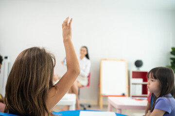 Caucasian beautiful young woman teacher teaching art to kids at school. 