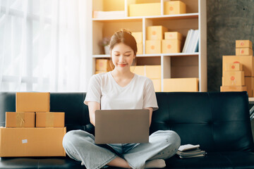 Asian woman working in modern warehouse and delivery service via modern technology