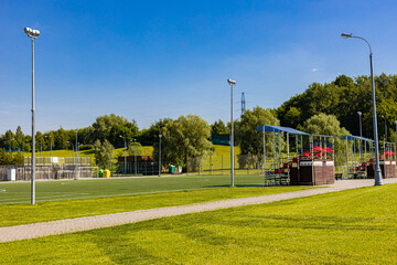 a fragment of a football field with empty stands standing on it