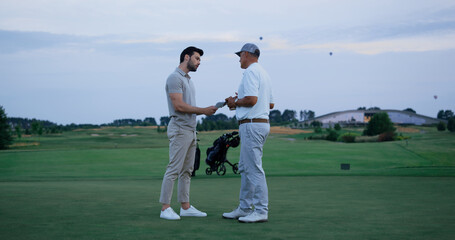 Golf team fight together at green course. Two men argue at country club field