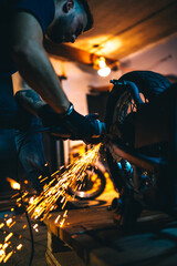 Motorcycle repair. Young man repairing motorbike in garage. Mechanic fixing motorcycle engine.