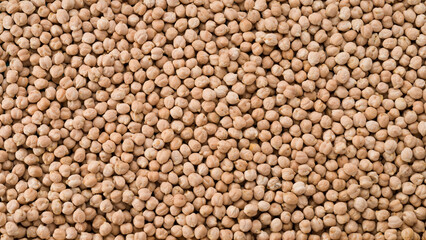 Food background from a texture of raw chickpeas close-up.  Dried organic chickpeas top view.  Vegan healthy diet concept
