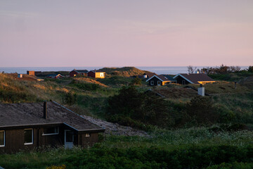 Fototapeta na wymiar Hirtshals, Denmark, Small vacation houses on the shore of the North Sea.