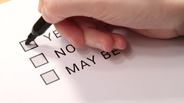 The person selects "Yes" on the questionnaire. Angle view. Selective focus.