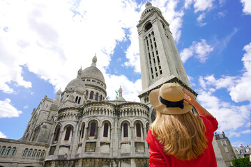Visiting Paris, France. Tourist woman in Paris with the Basilica of the Sacred Heart (Sacré-Cœur)...