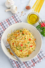 Top Down Vertical Photo of Spaghetti Aglio E Olio with Chili Peppers, Chili FlajesParsley and Garlic