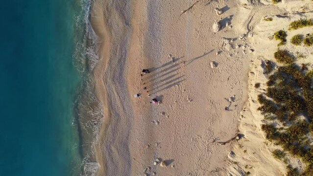 Drone shot of beautiful scenic beach with white sand and blue sea water, sunset, sunrise. Greece, Egremni beach of Lefkada island.