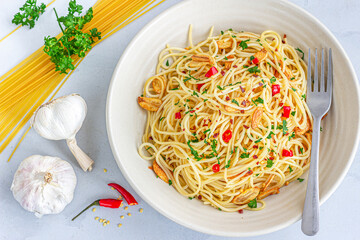 Traditional Italian Aglio E Olio Spaghetti Pasta with Chili Peppers, Chili FlajesParsley and Garlic Top Down Photo