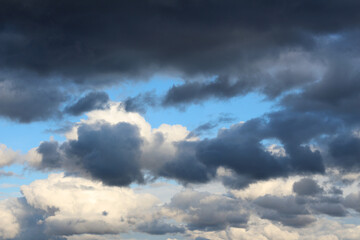Naklejka na ściany i meble Dark storm clouds on blue sky. Before the rain