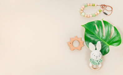 Baby accessories and toys banner with copy space in eco style with tropical monstera leaf. Lovely...