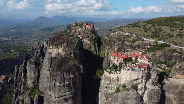 Aerial view of monastery Trinity and breathtaking pictures of valley and landmark canyon of Meteora, Polichni, Kalambaka, Greece. Mountains as columns