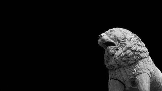 The Lion of Pisa, an ancient etruscan statue at the top of city ancient walls (Black and White with copy space)