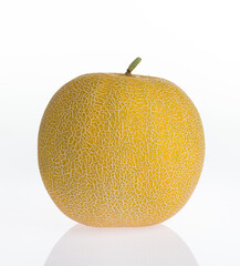 Melon isolated on a white reflective background. Organic sweet yellow melon