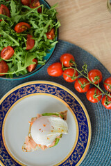 Poached Egg Benedict Toast with Avocado, Salmon and Rucola.