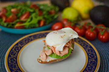 Poached Egg Benedict Toast with Avocado, Salmon and Rucola.