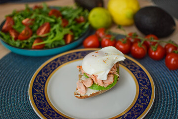 Poached Egg Benedict Toast with Avocado, Salmon and Rucola.