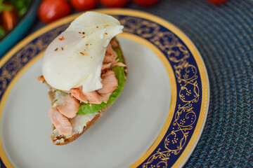 Poached Egg Benedict Toast with Avocado and Salmon.