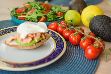 Poached Egg Benedict Toast with Avocado, Salmon and Rucola.