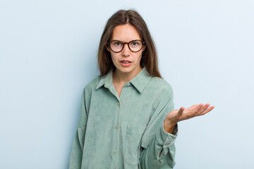 young adult pretty woman looking angry, annoyed and frustrated screaming wtf or what’s wrong with...