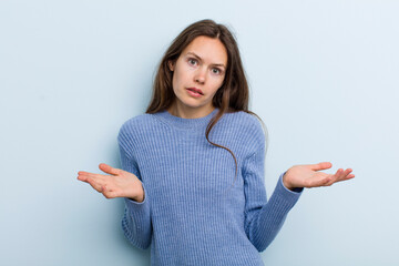 young adult pretty woman feeling puzzled and confused, unsure about the correct answer or decision,...