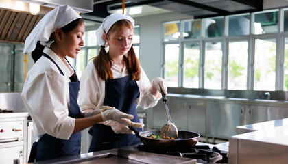 Group of student girl learning. Cooking class. culinary classroom. group of happy young woman multi...