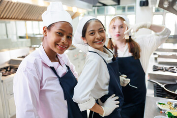 Group portrait young wman cooking student. Cooking class. culinary classroom. group of happy young...