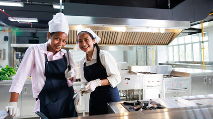 Group portrait young wman cooking student. Cooking class. culinary classroom. group of happy young woman multi - ethnic students are focusing on cooking lessons in a cooking school.