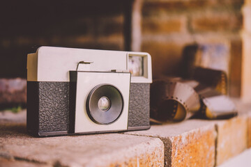 Vintage analog camera near a negative film