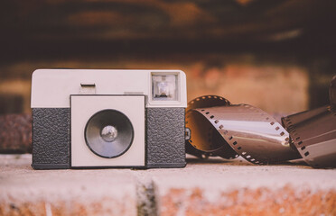 Vintage analog camera near a negative film