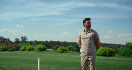 Golf course worker enjoy sunny day. Golfer inspecting player at fairway field.
