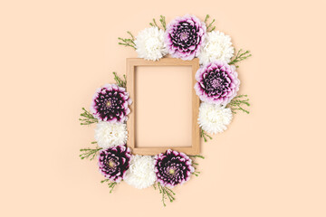 Flower border frame made of dahlia on a beige background. Springtime festive concept with copyspace.