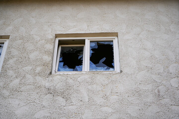 Broken, smashed window glass on an uninhabited building in Bavaria, photographed with the telephoto lens in March