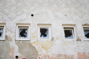 Broken, smashed window glass on an uninhabited building in Bavaria, photographed with the telephoto lens in March