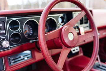 red steering wheel, dashboard of an old powerful classic American car