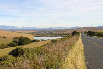 Obraz premium A view towards Ashton, South Africa, showing beautiful valleys and a dam.