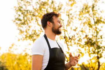 Happy man enjoying wine in countryside