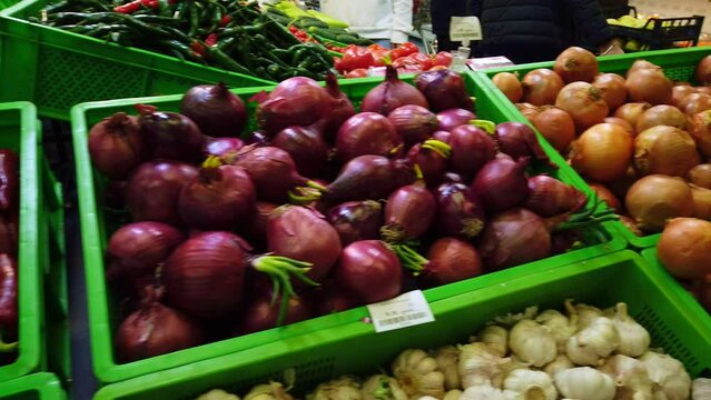 Vegetables in grocery store. onions, garlic. pepper and eggplant. Industry of selling products