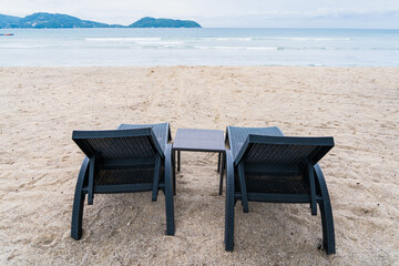 Fototapeta na wymiar Beach Chairs in front of the sea beach - Holiday relaxation background Concept