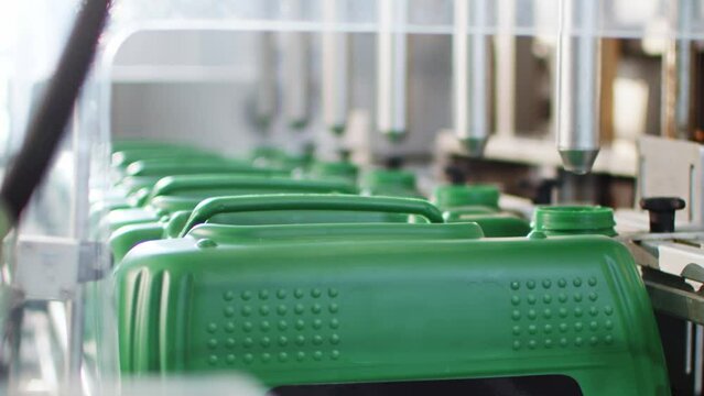 Pouring Liquid into Canisters Micro Fertilizer Production Factory