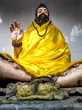 Feb 15th 2020. Tapkeshwar Mahadev Temple. Dehradun city, India. An ancient Indian Yogi colorful statue with a raised hand in a blessing posture.