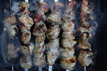 Pork kebab on skewers grilled on charcoal on the grill, raw meat, six skewers with meat