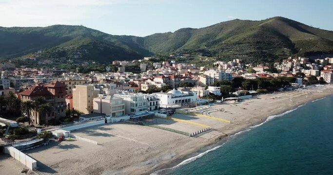 Panoramic shot by drone: sandy beach blue water and mountains. Genoa, Italy