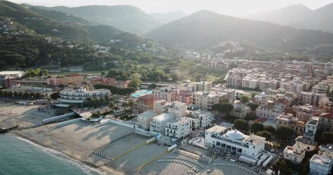 Drone aerial shot of an italian town next to the Mediterranean during a sunset. genoa, Italy