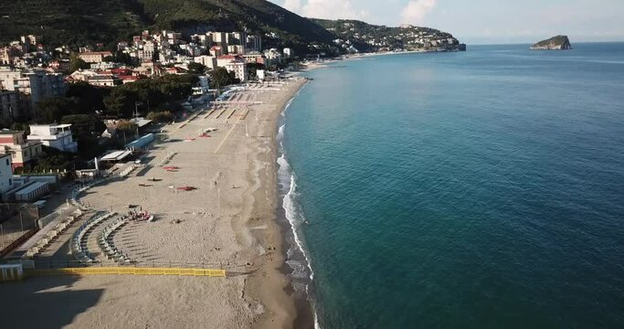 View of the Mediterranean shore, large sandy beach, town, mountains. aerial view, Italy