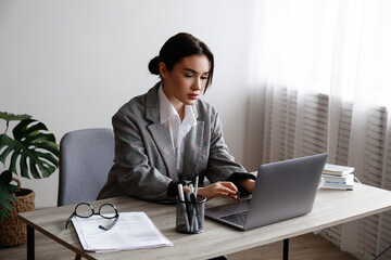 Young smart looking woman wearing glasses at the office, lawyer doing the paperwork. Portrait of...