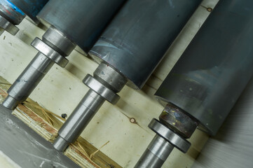 Used printing shafts for flexographic printing press. A set of rubberized knurling shafts in a...